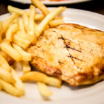 Grilled Breast of Chicken Served with French Fries or Rice and Refried Beans. OLE Flaco's.