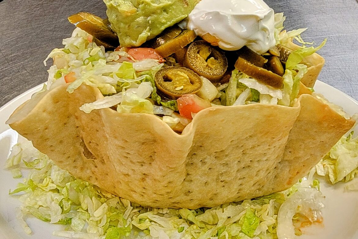 Ensalada de Taco (Taco Salad)- A wonderful Crisp Flour Tortilla Filled with Beans and a Choice of Chicken, or Ground Beef Topped with Lettuce, Cheese, Sour Cream, Guacamole and Sliced Jalapeño Pepper. Tacos all ways at Flacos Mexican Specialties and Steakhouse of Naples . Near to Bonita Springs
