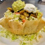 Ensalada de Taco (Taco Salad)- A wonderful Crisp Flour Tortilla Filled with Beans and a Choice of Chicken, or Ground Beef Topped with Lettuce, Cheese, Sour Cream, Guacamole and Sliced Jalapeño Pepper. Tacos all ways at Flacos Mexican Specialties and Steakhouse of Naples . Near to Bonita Springs