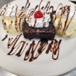 > A Warm Chocolate Brownie Topped with Vanilla Ice Cream, Fudge Sauce and Whipped Cream at fantastic restauarant in Naples Florida, just south of Bonita Springs