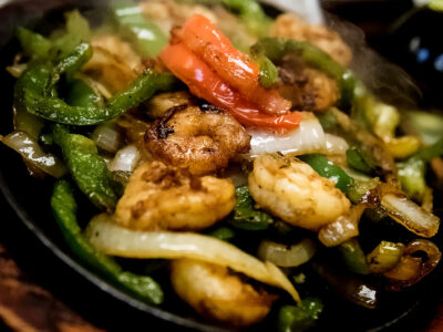 Mexican Fajita's that will make you sizzle in Naples- Flaco's Fajita's Camarones- Sizzling Shrimp marinated and cooked to perfection! Served with Green Peppers, Onions, Tomatoes, Guacamole, Sour Cream, Flour Tortillas, Rice and Refried Beans