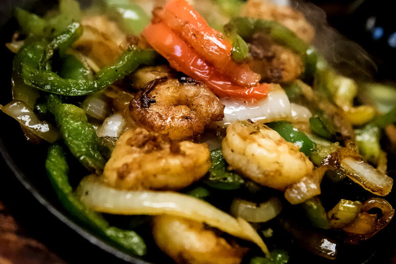 Mexican Fajita's that will make you sizzle in Naples- Flaco's Fajita's Camarones- Sizzling Shrimp marinated and cooked to perfection! Served with Green Peppers, Onions, Tomatoes, Guacamole, Sour Cream, Flour Tortillas, Rice and Refried Beans