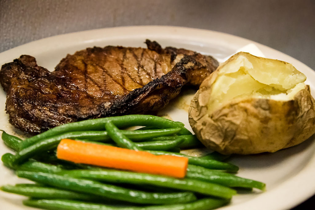 Bistec Mexicano Strip Steak 12 oz. Perfect Seasonings, tender and Delicious. Choice of Rice or Baked Potato- Served with Sautéed Green Beans and Carrots. For the best steak in Naples, come to Flaco's Mexican Restaurant