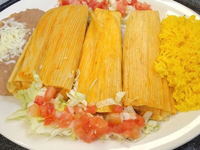 Three House Made Pork Tamales, Served with Guacamole, Sour Cream, Rice and Refried Beans