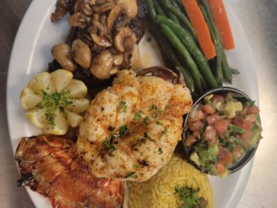 Flaco’s Surf and Turf › 12 Oz Gulf Lobster Tail and 8 Oz Filet Mignon, Cooked to Perfection. Choice of Rice or Baked Potato- Served with Sautéed Green Beans and Carrots, drawn butter, and a side of Pico de Gallo.